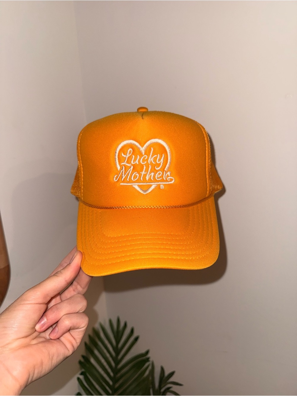 Mommday lucky mother trucker hat with white heart. Momland